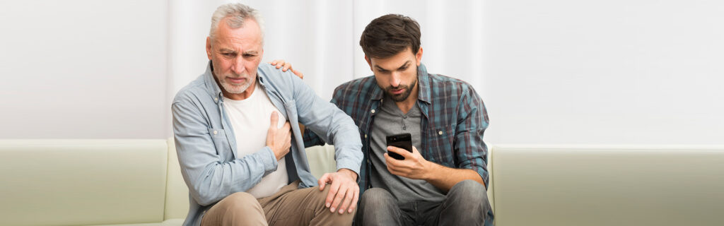 Elderly man with chest pain being assisted, symbolizing emergency care for cardiac issues.