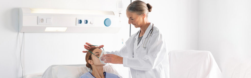 Doctor assisting a patient with an oxygen mask, symbolizing urgent care for respiratory issues.